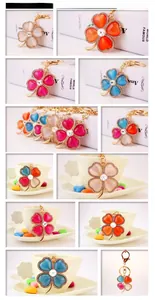 Detailed close-up of multi-color clover keychains with crystals and cat eye stones