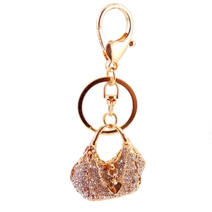 Elegant rhinestone handbag keychain with golden heart pendant and dual clasps on white background