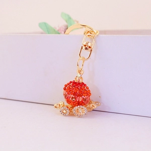 Exquisite gold pumpkin carriage keychain with red and white rhinestones for bags