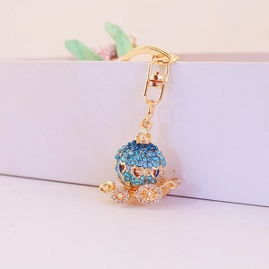 Golden pumpkin carriage keychain with blue rhinestones and sparkling heart accents
