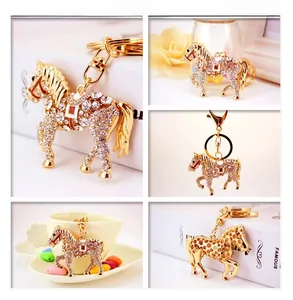 Detail of horse-shaped keychain with white rhinestones and red enamel saddle accents