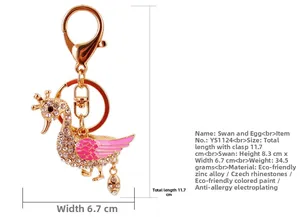 Detail showing dimensions of a swan keychain with crystals and pink enamel finish