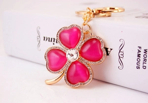 Detail of clover keychain with pink cat eye stones and sparkling crystal accents