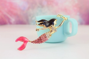 Detailed close-up of mermaid keychain with pink rhinestones and gold metal finish