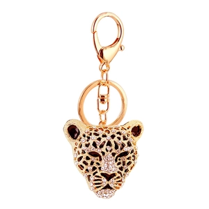 Golden leopard head keychain with sparkling rhinestones and lobster clasp on white background
