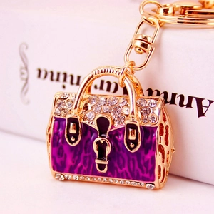 Golden handbag keychain with purple leopard print enamel and sparkling rhinestones