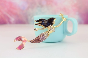 Close-up of mermaid keychain featuring purple gradient scales and sparkling rhinestones