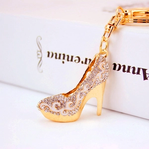 Elegant high heel keychain featuring gold plating, white crystals, and enamel wave patterns