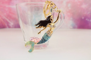 Macro view of mermaid keychain with gradient blue rhinestones and gold metal lobster clasp