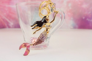 Detail of mermaid keychain with purple rhinestones and golden lobster clasp