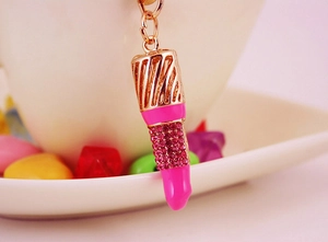 Detalle macro del llavero de pintalabios con cristales rosas y esmalte brillante
