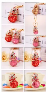Close-up of sparkling rhinestone pig keychains with Chinese Fu character and gold plating