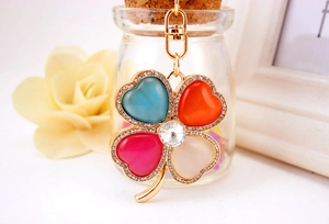 Detailed macro view of the gold alloy clasp and colorful clover keychain with rhinestones
