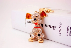 Close-up of golden Dalmatian dog keychain with sparkling crystals and enamel dots
