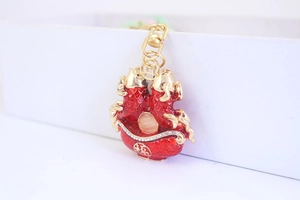 Macro view of koi fish keychain with red enamel, gold frame, rhinestones and Fu character