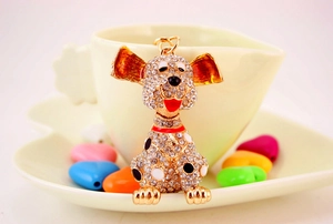 Close-up of cute Dalmatian dog keychain with sparkling rhinestones and gold-tone details