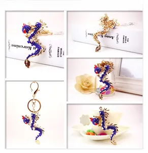 Detailed views of the golden Chinese dragon keychain with blue and red crystals