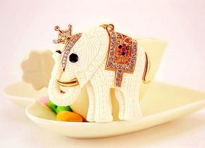 Detailed close-up of ivory elephant keychain featuring gold crown and crystal saddle