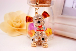 Close-up of sparkling crystal-studded dog keychain with red and black enamel details