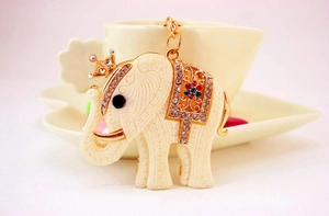 Detailed view of resin white elephant keychain with gold crown and colorful rhinestones