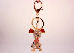 Detailed view of spotted dog keychain featuring full crystal rhinestones and enamel accents