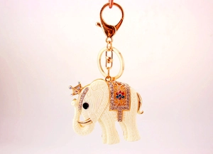 Detailed view of resin elephant charm with golden crown and colorful rhinestone saddle