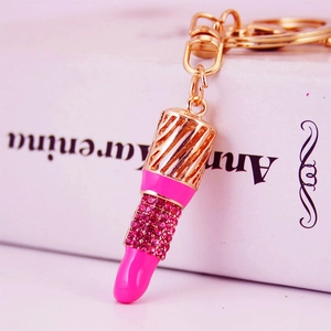 Pink rhinestone-studded lipstick keychain charm with gold metal chain and D-ring clip