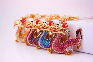 Macro detail of multicolored dragon keychains featuring vibrant crystals and gold finish