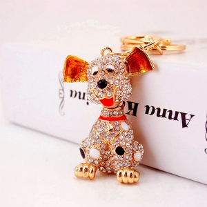 Sparkling crystal spotted dog keychain with gold plating and red enamel details