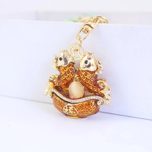 Golden Chinese carp keychain with orange enamel details and white crystal embellishments