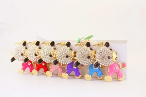 Close-up of 6 colorful enamel ox keychains with sparkling rhinestones and golden finish