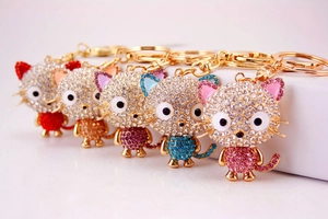 Detailed view of colorful crystal cat keychains with rhinestones and gold alloy bases