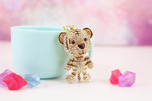 Close-up of a sparkling tiger keychain featuring full crystal pave and golden finish
