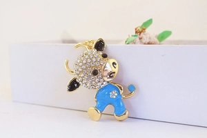 Detailed view of a cute cartoon ox charm with sky blue enamel and sparkling rhinestones