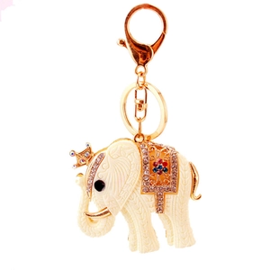 Cute resin elephant keychain with golden crown and floral saddle on white background