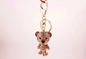 Close-up of golden tiger keychain with sparkling rhinestones and a metal lobster clasp