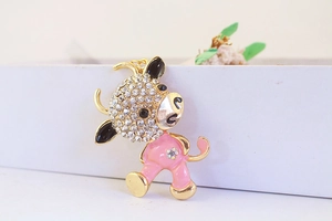 Detailed view of pink cartoon ox keychain with rhinestones on a white gift box