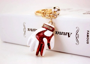 Detail view of sport keychain with red boxing glove and mini football charms