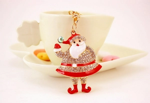 Detailed macro shot of a Santa Claus keychain with inlaid rhinestones and red enamel coating