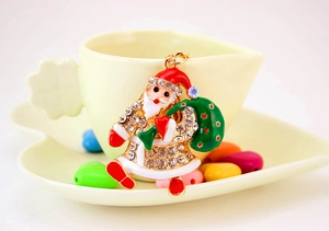 Close-up of Santa Claus keychain with red enamel and sparkling crystal details