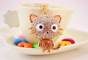 Detail of cute cat keychain with sparkling crystal rhinestones and gold metal finish