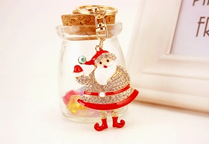 Detail of Santa Claus keychain with sparkling rhinestones and red enamel coating