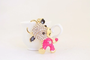 Close-up of cute pink enamel ox keychain with sparkling rhinestones and gold alloy base