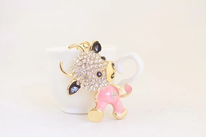 Detail of cute cartoon ox keychain with pink enamel and sparkling crystal rhinestones