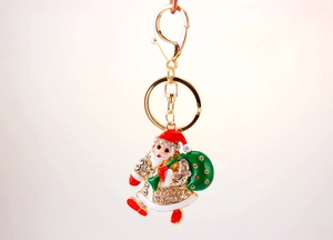 Macro detail of Santa Claus keychain with sparkling rhinestones and colorful enamel