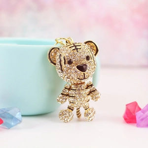 Sparkling tiger zodiac keychain with crystals on a blue cup background with soft lighting