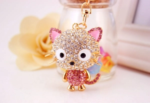 Close-up of pink crystal cat keychain with sparkling rhinestones and gold metal clasp