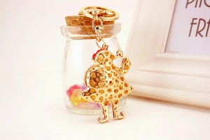 Detail of Santa Claus keychain featuring gold-plated metal with hollow heart patterns