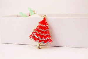 Detailed close-up of a sparkling rhinestone-studded red Christmas tree keychain pendant