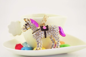 Close-up of a horse keychain with sparkling rhinestones and a purple mane detail